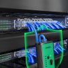 UGREEN multifunctional RJ45 LAN and RJ11 telephone cable tester showing signal tracking on a server rack.